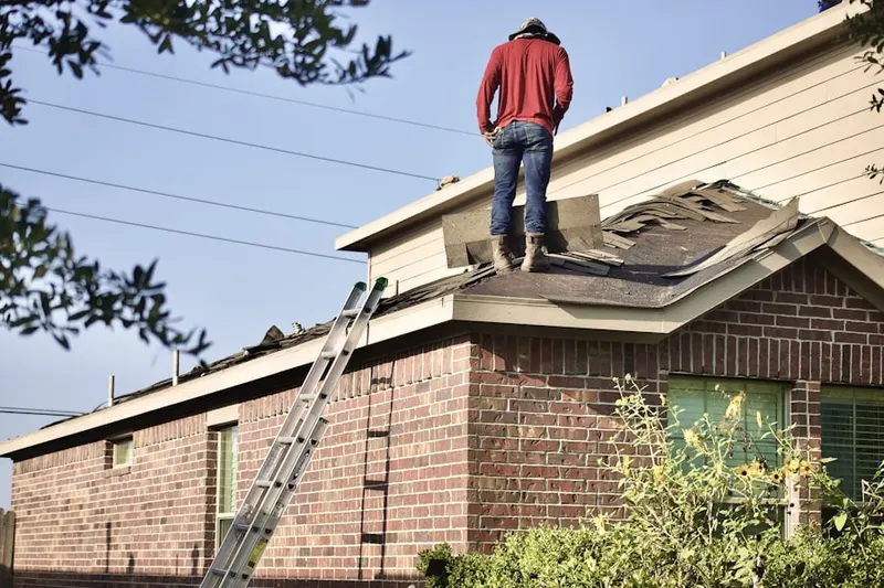 Professional roofer working on a residential roof in South Mountain Manor